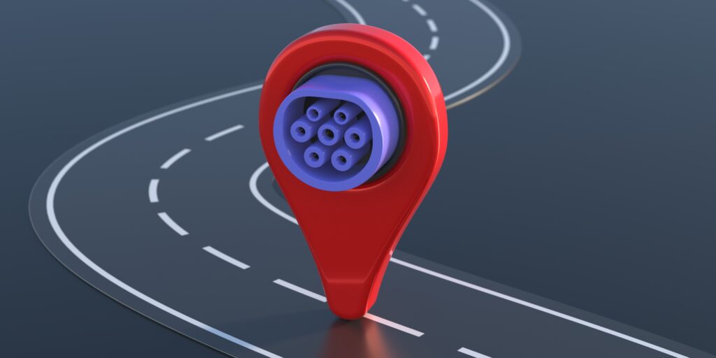 3D illustration of a red map pin with a purple concentric circle symbol, resembling an electric vehicle charging icon, placed on a curving road.